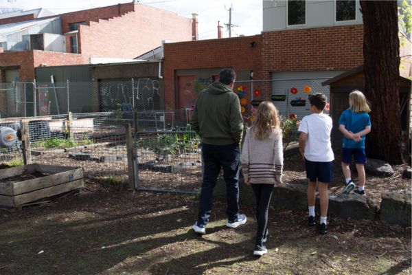 Students taking Rob Rees to visit the garden at Fitzroy North Primary School