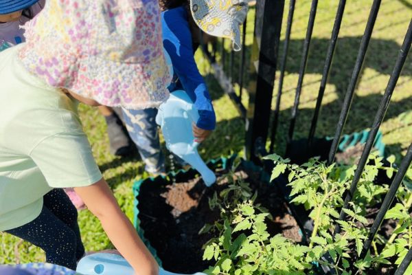 Kids watering plants at Happy Trails ELC
